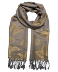 A grey and gold reversible pashmina scarf with a butterfly design, fringed ends, and a knotted tie at the center.